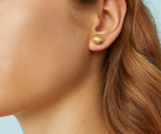 A real must-have, these 18K gold stud earrings are discreet and always elegant, perfect for everyday wear. The surface is hand-engraved using an ancient Florentine technique which gives our gold a fine, brushed texture.