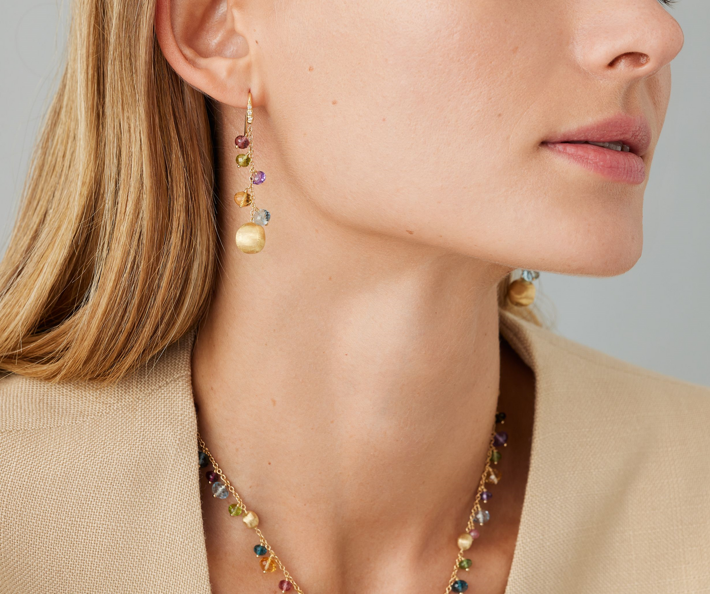 In a perfect interplay of proportions, the colorful gemstones lend character and shine to these 18K yellow gold long drop earrings. The gold beads are finely hand engraved using the ancient Florentine technique, while the hook is adorned with a pavé of diamonds.