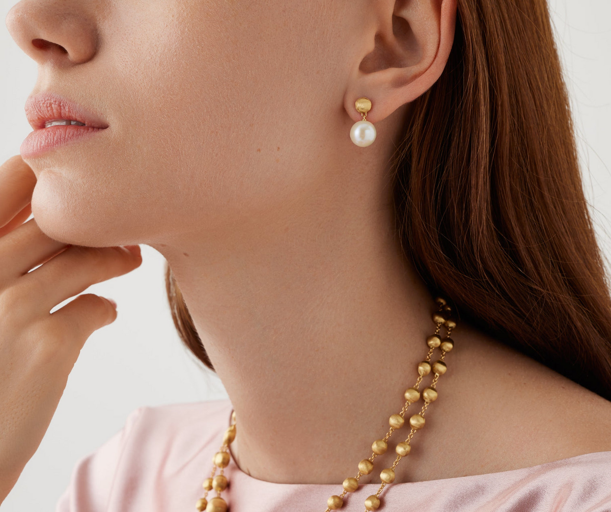 A real must-have, these petite 18K gold pearl drop earrings are discreet and always elegant, perfect for everyday wear. The surface is finely hand-engraved using the ancient Florentine technique which gives our gold a fine, brushed texture.
