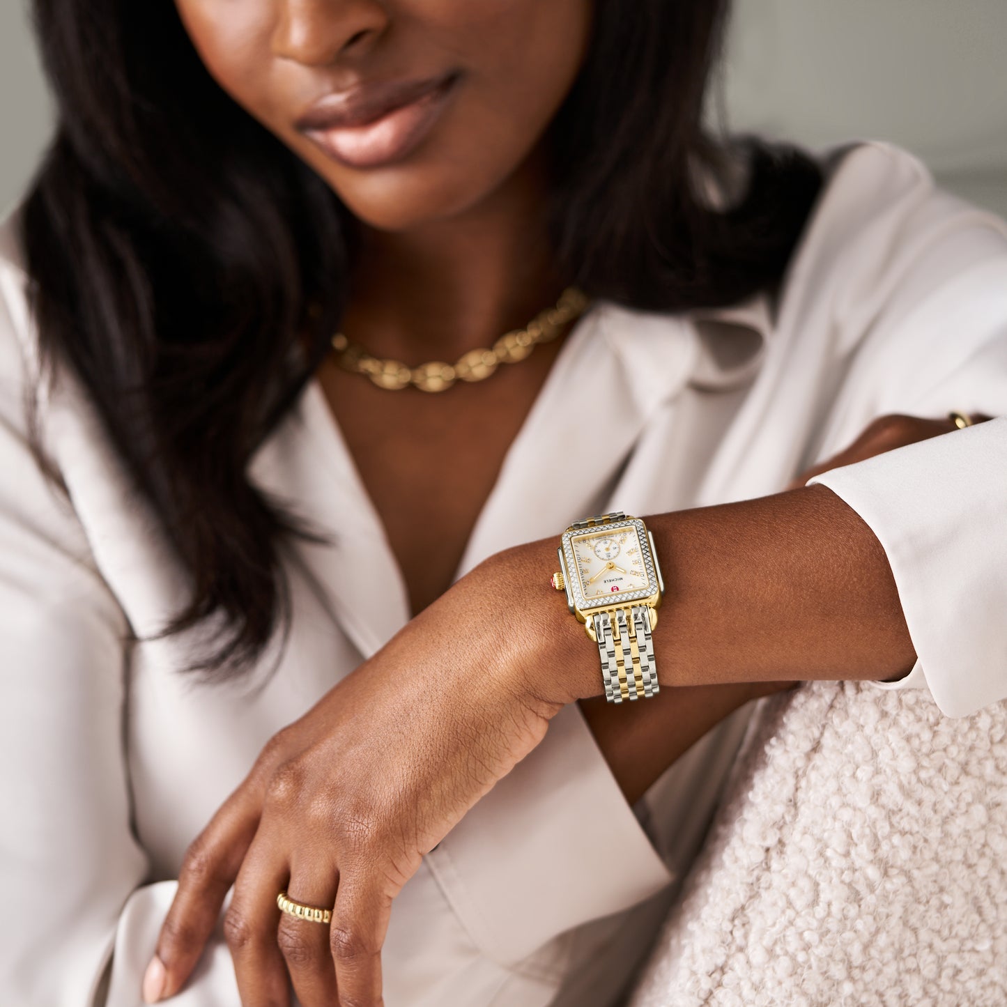 Inspired by the geometric shapes of Art Deco architecture, this two-tone Deco Mid shines with 126 hand-set diamonds (0.57 carat weight) on the bezel and atop the white mother-of-pearl dial adorned with double diamond hour markings. The signature MICHELE crown accents this stunning timepiece with a Swiss movement and the iconic seven-link two-tone stainless and 18K gold-plated bracelet is interchangeable with any 16mm MICHELE strap.