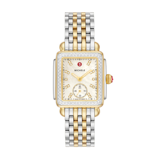 Inspired by the geometric shapes of Art Deco architecture, this two-tone Deco Mid shines with 126 hand-set diamonds (0.57 carat weight) on the bezel and atop the white mother-of-pearl dial adorned with double diamond hour markings. The signature MICHELE crown accents this stunning timepiece with a Swiss movement and the iconic seven-link two-tone stainless and 18K gold-plated bracelet is interchangeable with any 16mm MICHELE strap.