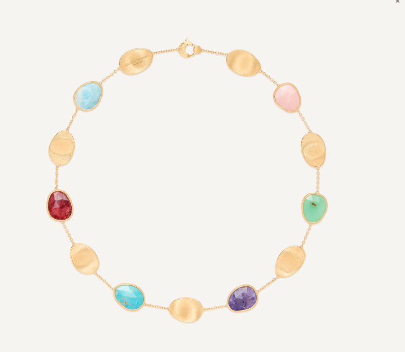 Elegant and striking, this necklace features a refined sequence of light 18K yellow gold leaves and a mix of colorful gemstones. The gold leaves are meticulously hand-engraved using the ancient Florentine technique, interspersed with a delicate chain. The perfect piece to complete any look with a vibrant touch of color.
