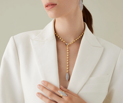 Delicate and precious, this 18K yellow gold lariat necklace is finely hand-engraved using the ancient Florentine technique, which gives our gold a fine, brushed texture. It features a central diamond spotlight and an eye-catching oval shape pavé-set diamond pendant, drawing the eye towards the décolletage. The adjustable length provides the perfect fit and endless possibilities for any neckline, outfit, or occasion.