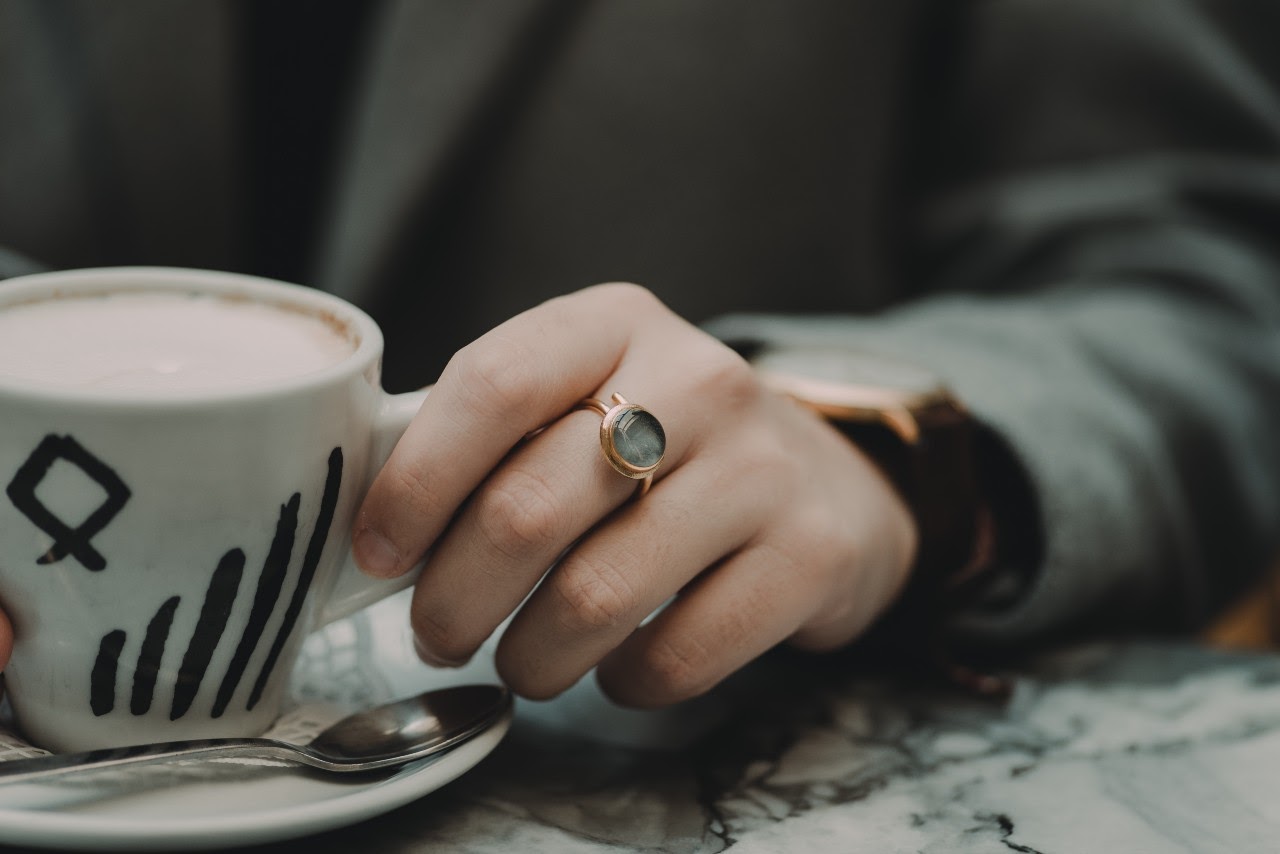 fashion ring on woman with coffee