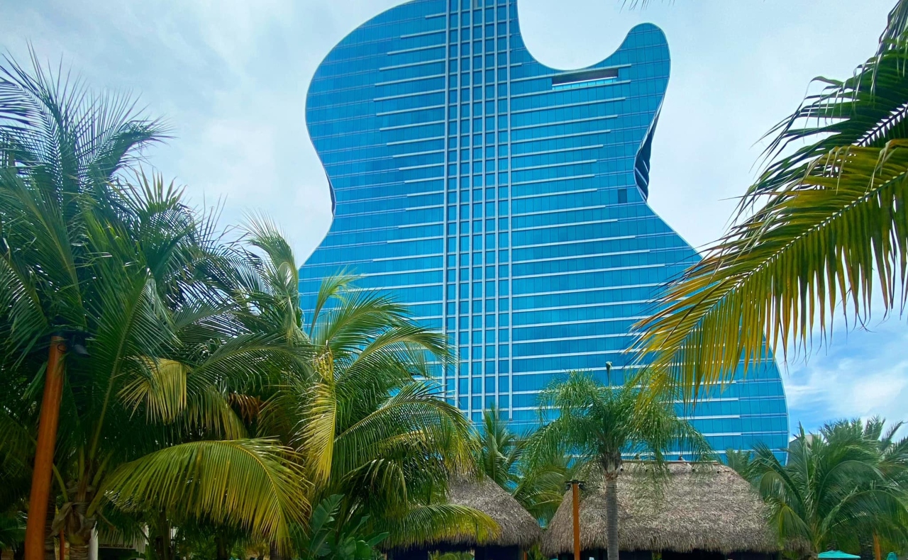 The Hard Rock Guitar Hotel in Hollywood Florida in front of a cloudy sky.