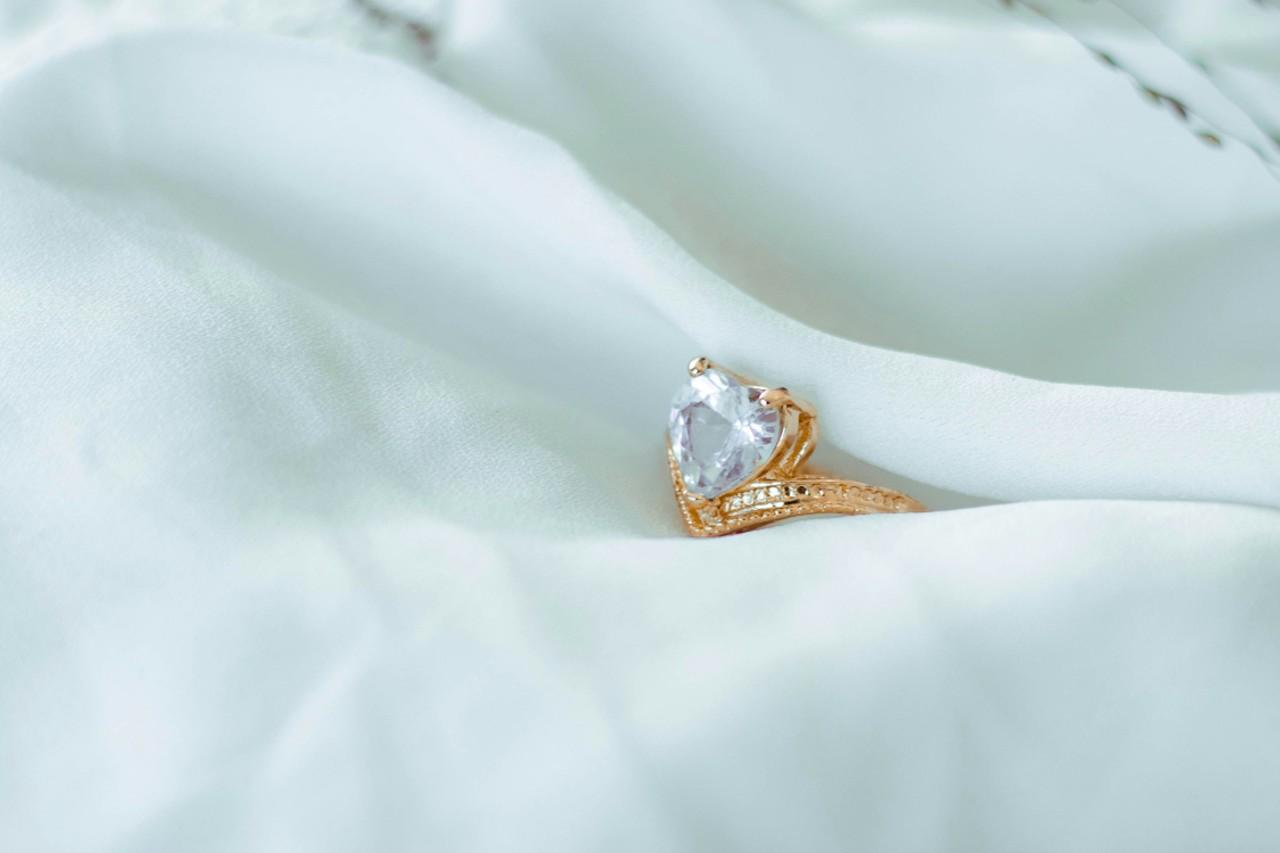 a unique engagement ring with a heart shaped center diamond