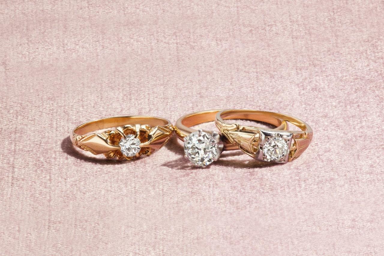 three uniquely designed yellow gold and diamond engagement rings