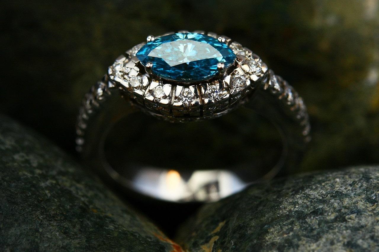 an engagement with with a horizontally oriented blue marquise cut center stone