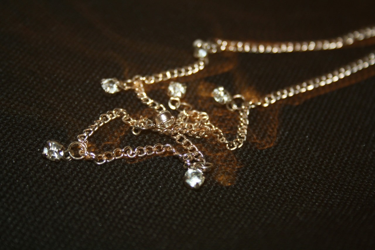 A close-up of a simple yet elegant yellow gold necklace.